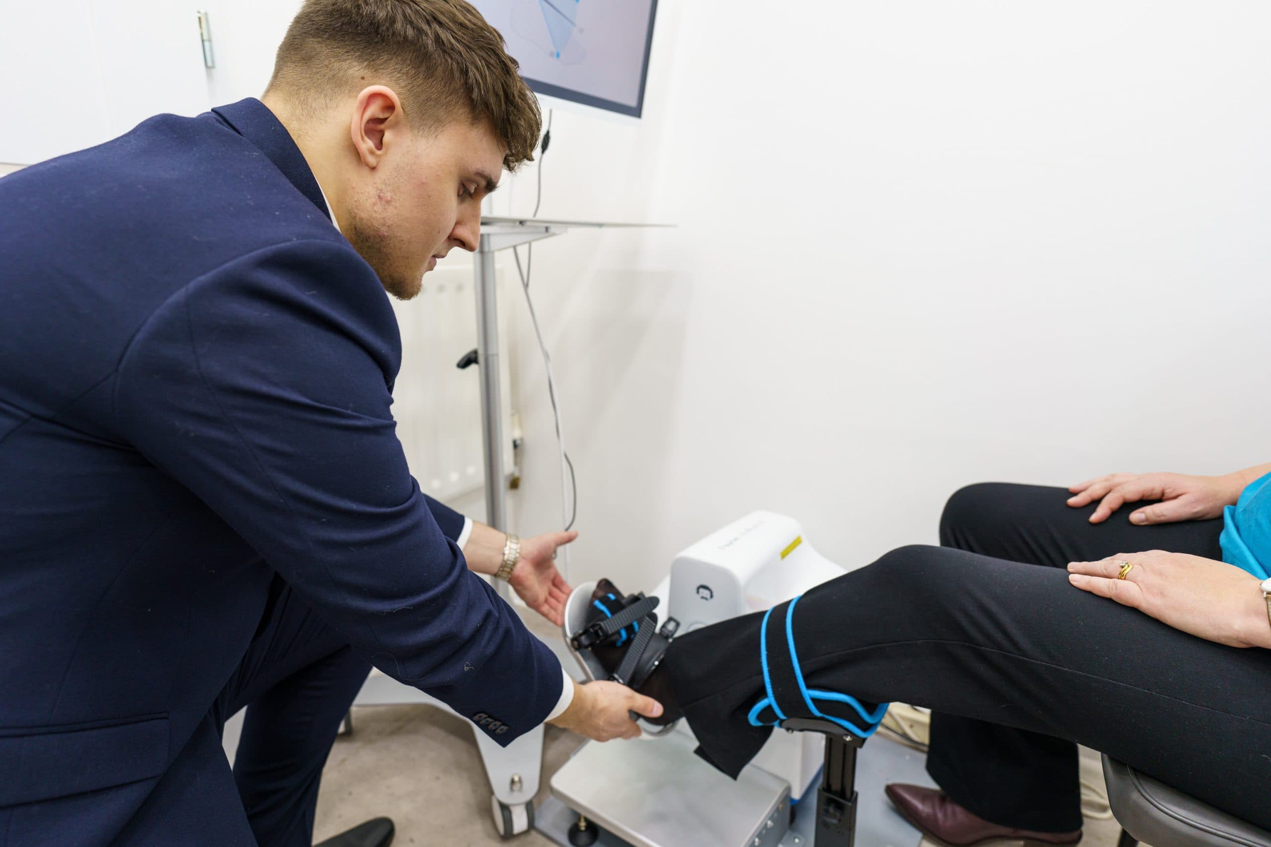 Clinician adjusting ankle and knee support device